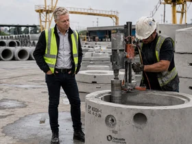Erik Hall observing concrete core drilling in a precast production yard